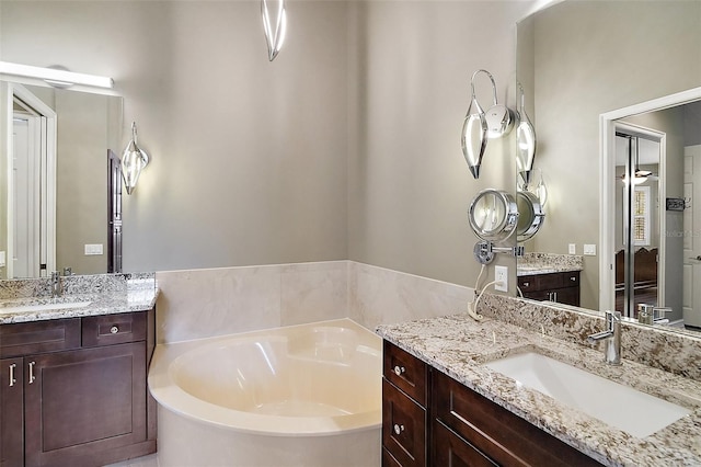 bathroom with a bath and vanity