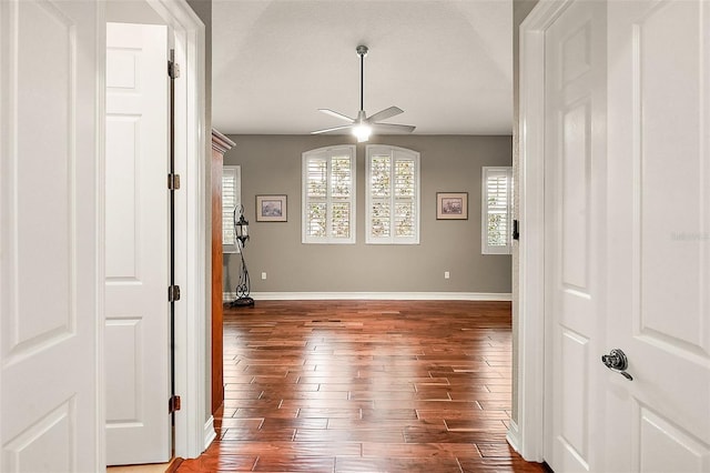 spare room featuring dark wood-type flooring and ceiling fan