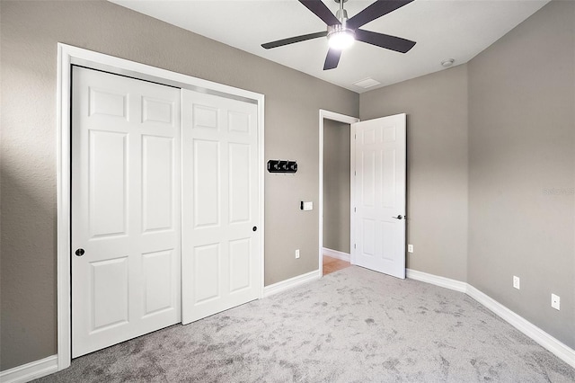 unfurnished bedroom with carpet flooring, ceiling fan, and a closet