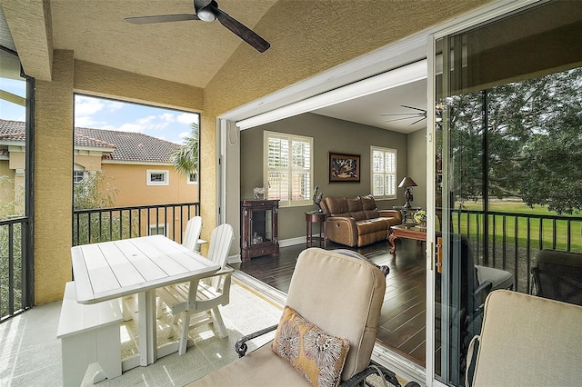 sunroom / solarium featuring ceiling fan and vaulted ceiling