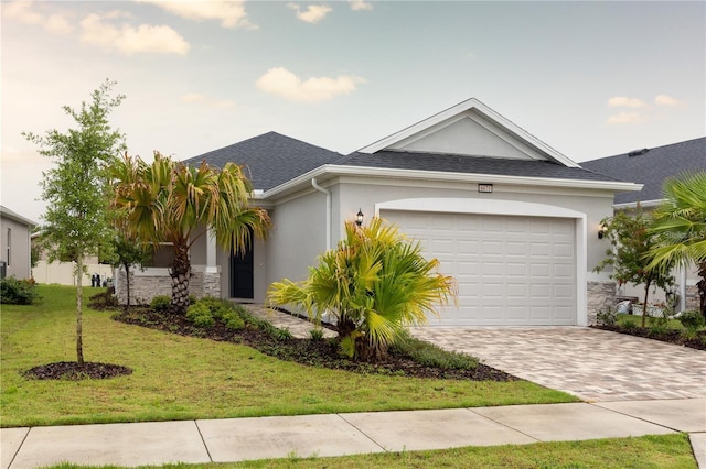 ranch-style home featuring a front lawn and a garage