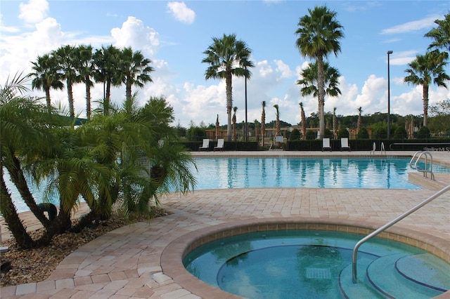 view of pool with a community hot tub