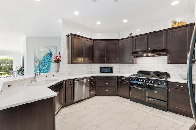 kitchen featuring crown molding, sink, appliances with stainless steel finishes, tasteful backsplash, and dark brown cabinetry