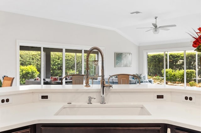 kitchen featuring vaulted ceiling, ceiling fan, and sink