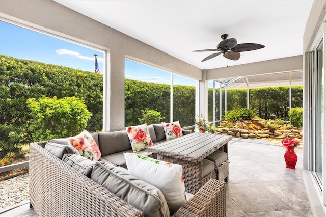 sunroom featuring ceiling fan