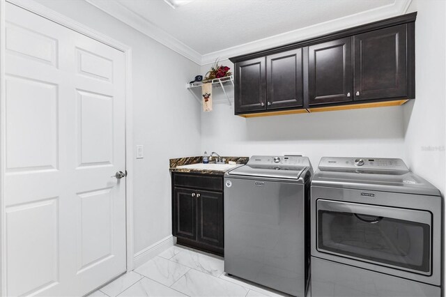 laundry room with washer and dryer, crown molding, cabinets, and sink