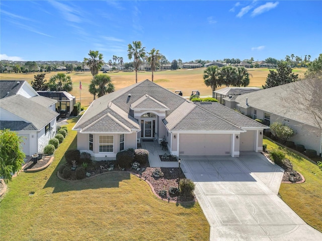 view of front of property featuring a garage and a front lawn