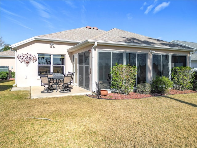 back of house with a yard, a patio area, and a sunroom