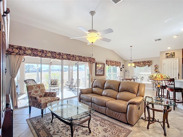 living room featuring ceiling fan, vaulted ceiling, and light tile patterned floors