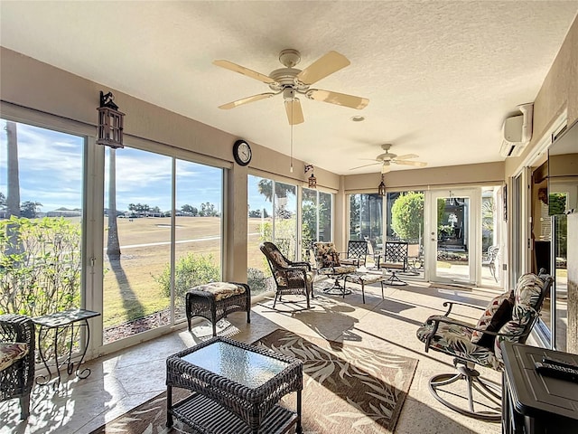 sunroom featuring plenty of natural light and a wall mounted AC