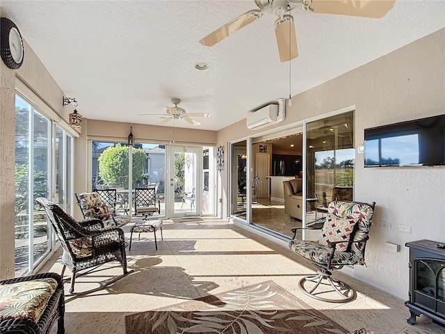 sunroom with ceiling fan, a wall mounted AC, and a wood stove