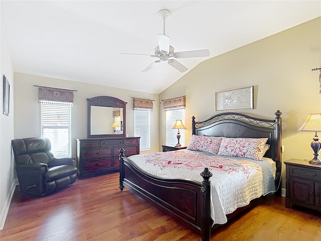 bedroom with multiple windows, vaulted ceiling, hardwood / wood-style floors, and ceiling fan