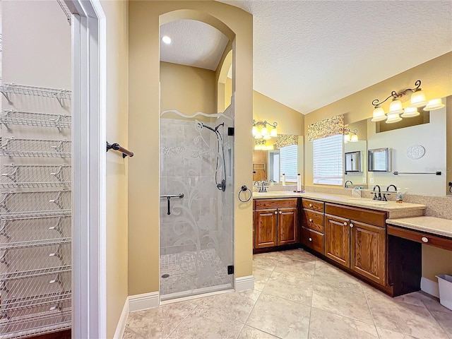 bathroom with lofted ceiling, tile patterned flooring, vanity, a textured ceiling, and a shower with shower door