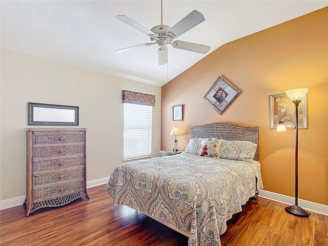 bedroom featuring hardwood / wood-style floors, vaulted ceiling, a textured ceiling, and ceiling fan