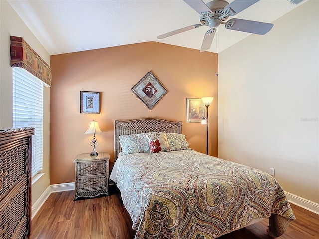 bedroom with hardwood / wood-style flooring, vaulted ceiling, and ceiling fan