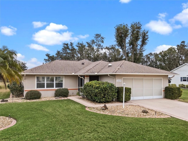 single story home featuring a garage and a front yard