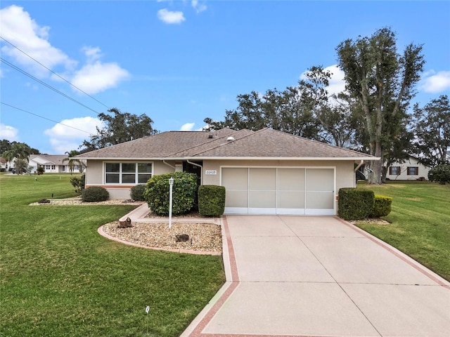 ranch-style house featuring a front lawn and a garage