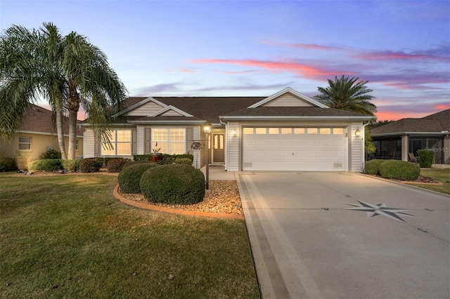 ranch-style home with a lawn and a garage