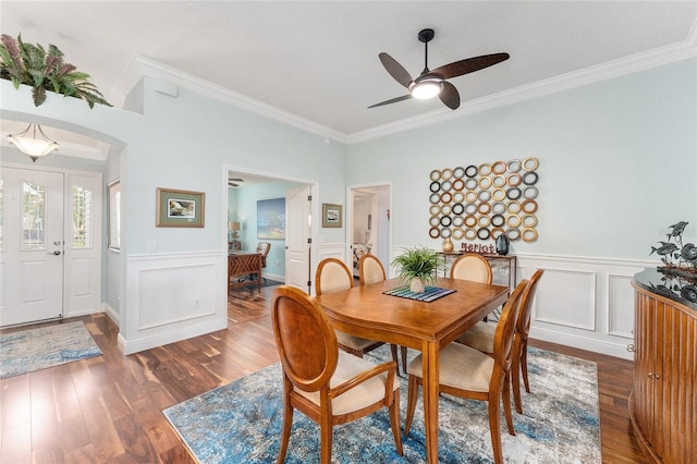 dining area with crown molding, ceiling fan, and dark wood-type flooring