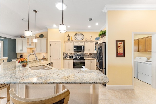 kitchen featuring pendant lighting, a large island, sink, and appliances with stainless steel finishes