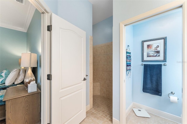 bathroom featuring tiled shower, tile patterned floors, and crown molding