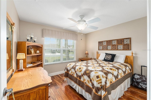 bedroom featuring dark hardwood / wood-style flooring and ceiling fan