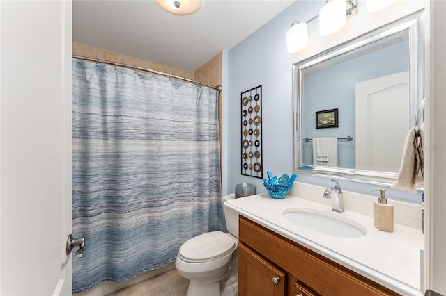 bathroom with vanity, tile patterned floors, a shower with shower curtain, toilet, and a textured ceiling