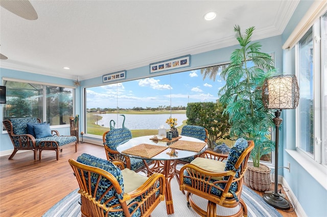 sunroom / solarium featuring a water view