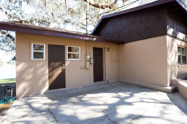 property entrance with a patio area