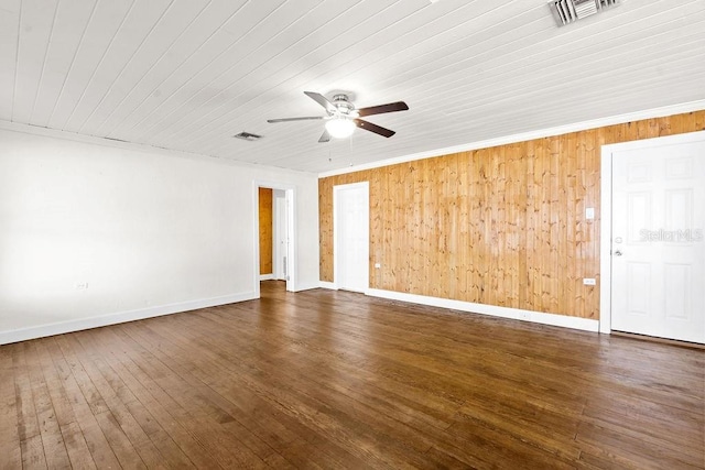 empty room featuring ceiling fan, dark wood-type flooring, ornamental molding, and wood ceiling