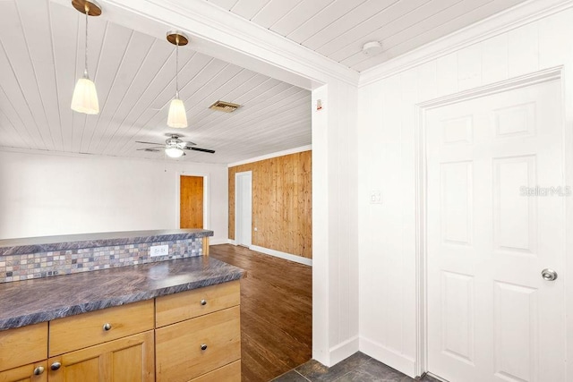 kitchen featuring ceiling fan, crown molding, wood walls, and pendant lighting