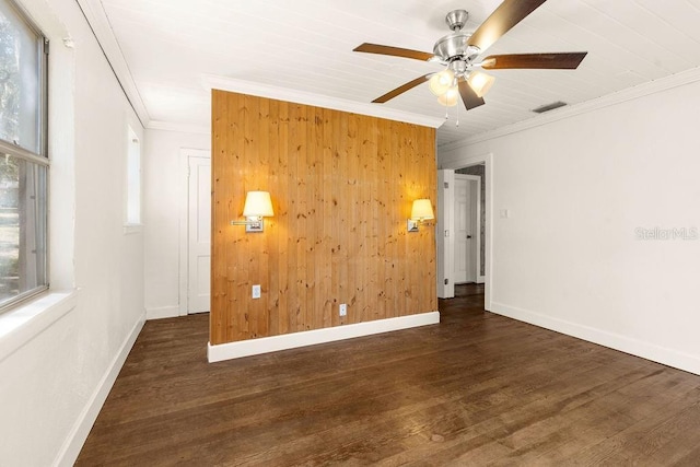 unfurnished room with ceiling fan, dark hardwood / wood-style flooring, and crown molding