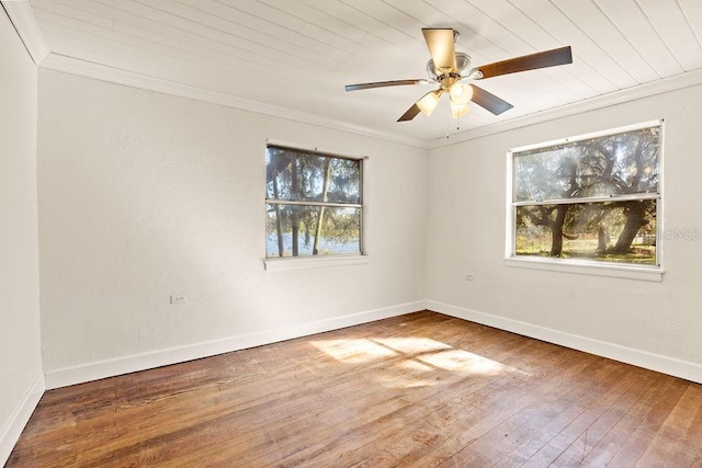 spare room featuring wooden ceiling, a healthy amount of sunlight, hardwood / wood-style floors, and crown molding