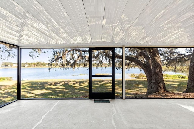 unfurnished sunroom with a water view and plenty of natural light