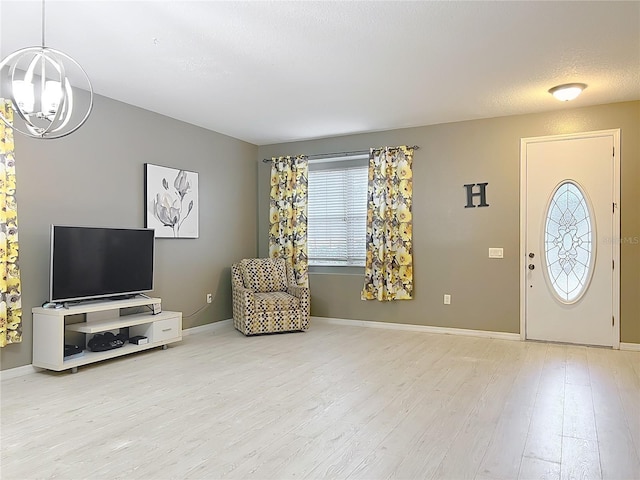 foyer entrance with wood-type flooring and a textured ceiling