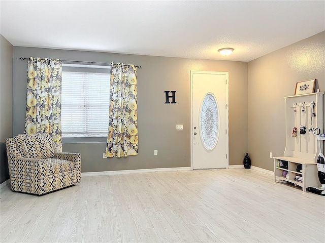 foyer with hardwood / wood-style floors and a textured ceiling