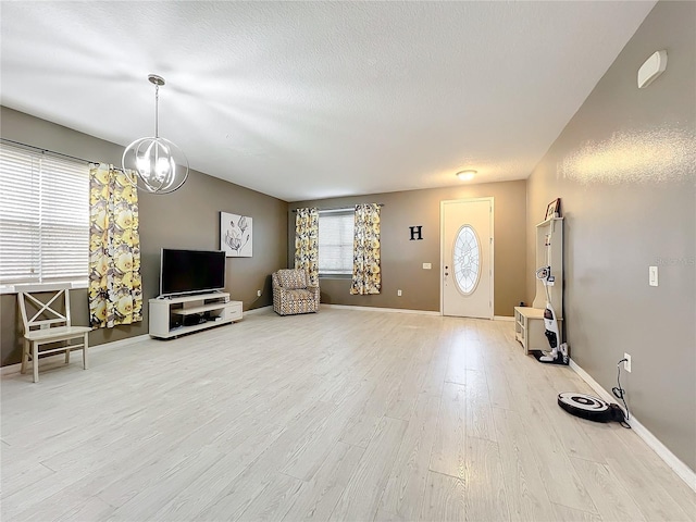 unfurnished living room featuring hardwood / wood-style floors and a notable chandelier