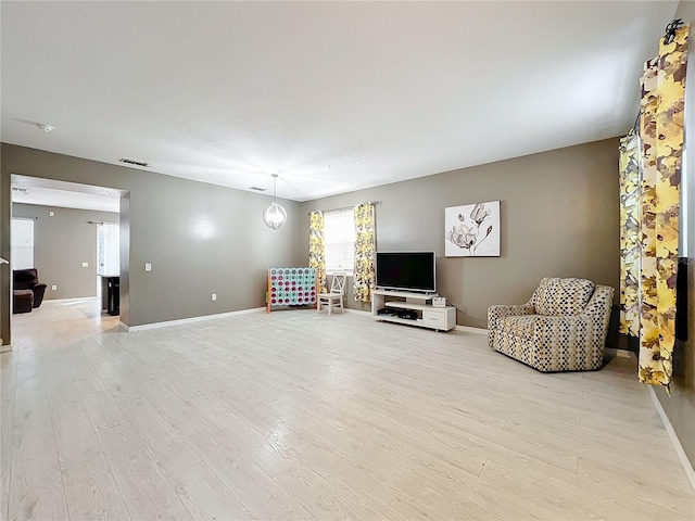 living area with light hardwood / wood-style flooring