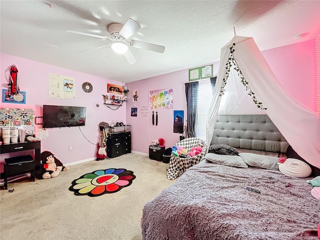 carpeted bedroom with a textured ceiling and ceiling fan