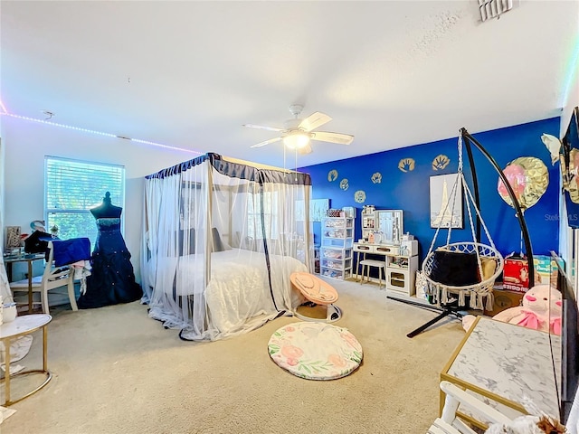 carpeted bedroom featuring ceiling fan and multiple windows