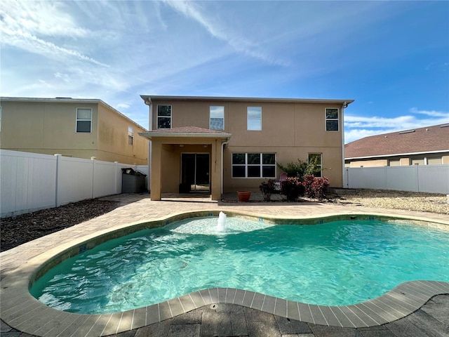 view of pool with a patio and pool water feature