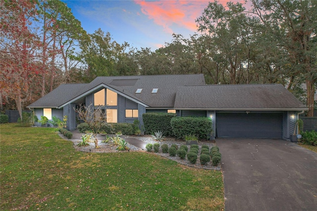 view of front of house with a yard and a garage