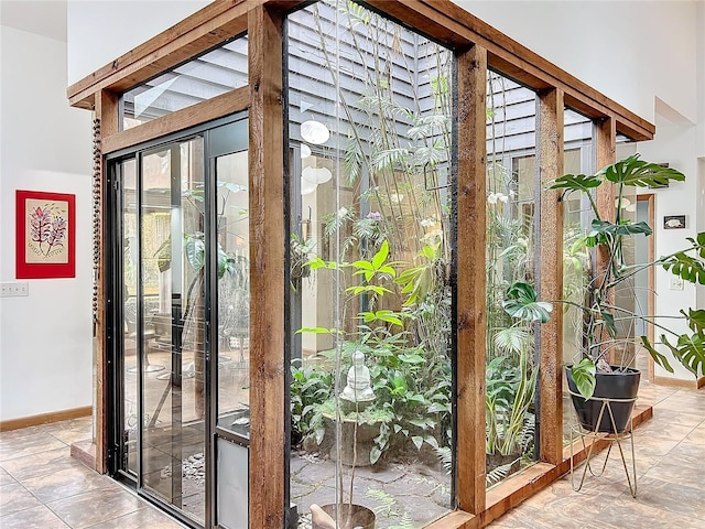 doorway with a healthy amount of sunlight and baseboards