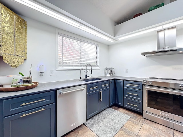 kitchen with wall chimney exhaust hood, blue cabinets, stainless steel appliances, light countertops, and a sink