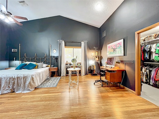 bedroom with lofted ceiling, a closet, light wood-type flooring, and visible vents