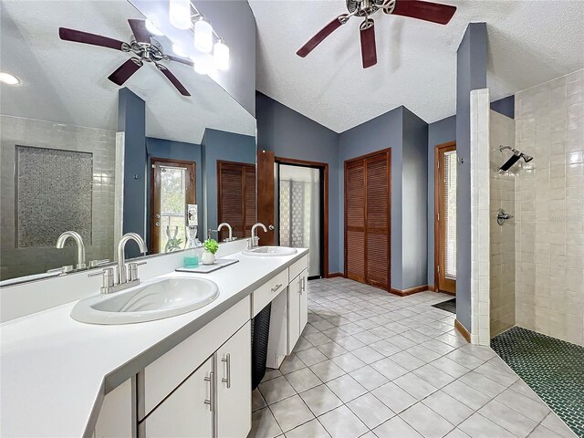 full bathroom with vaulted ceiling, a closet, a sink, and double vanity