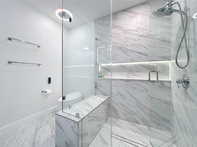 bathroom with toilet, marble finish floor, a marble finish shower, and baseboards