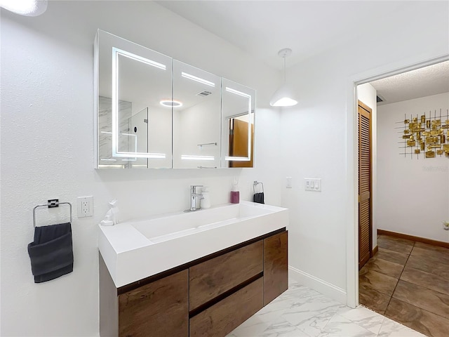 bathroom with visible vents, vanity, baseboards, marble finish floor, and a closet