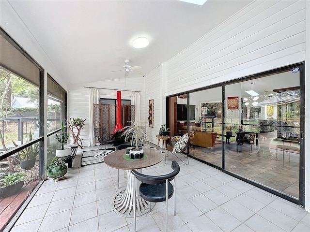 sunroom featuring ceiling fan and vaulted ceiling