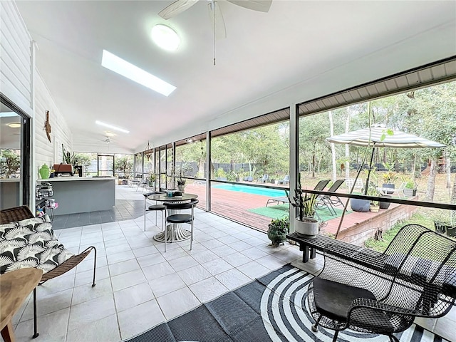 sunroom featuring a wealth of natural light, vaulted ceiling, and ceiling fan